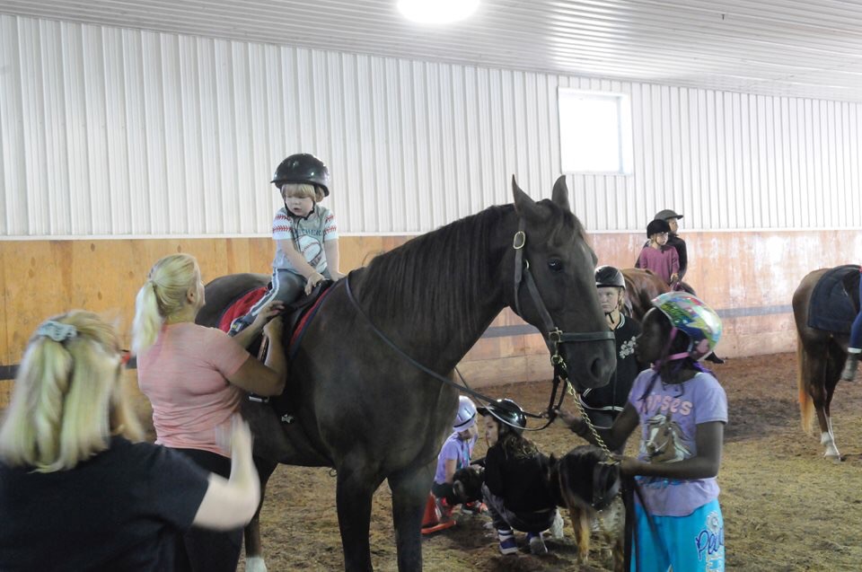 Evelyn's very first time on a horse at summer camp