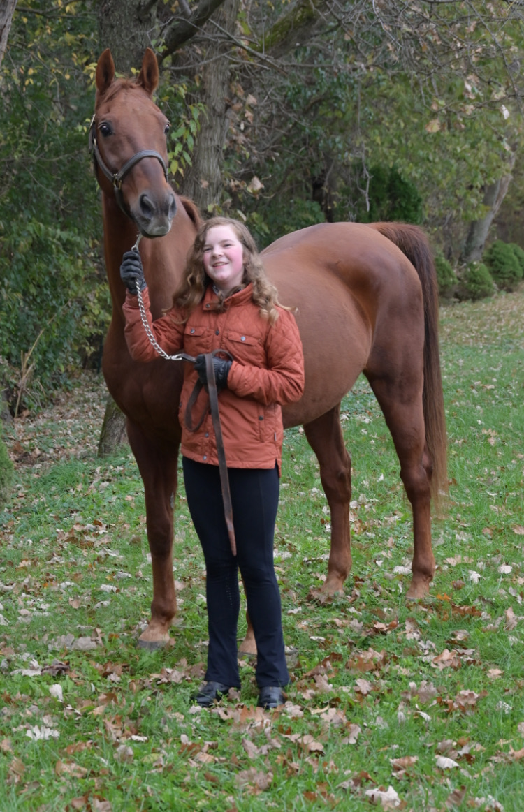 Evelyn standing with her horse